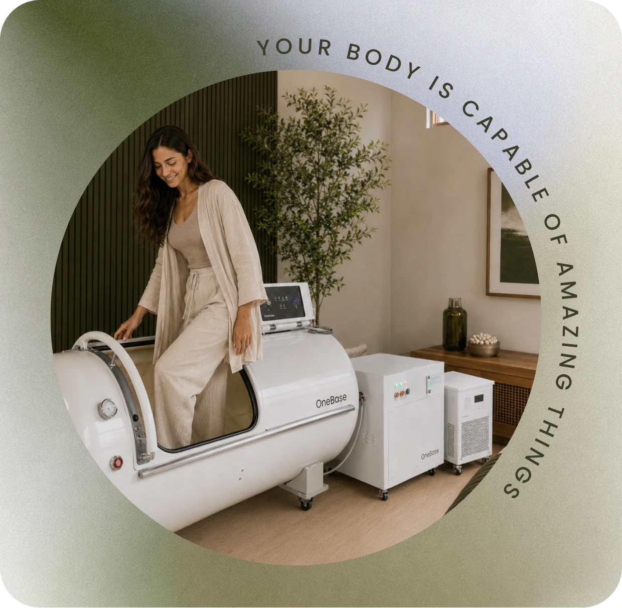 A guest beside the hyperbaric oxygen chamber at Restore Body & Mind Studio