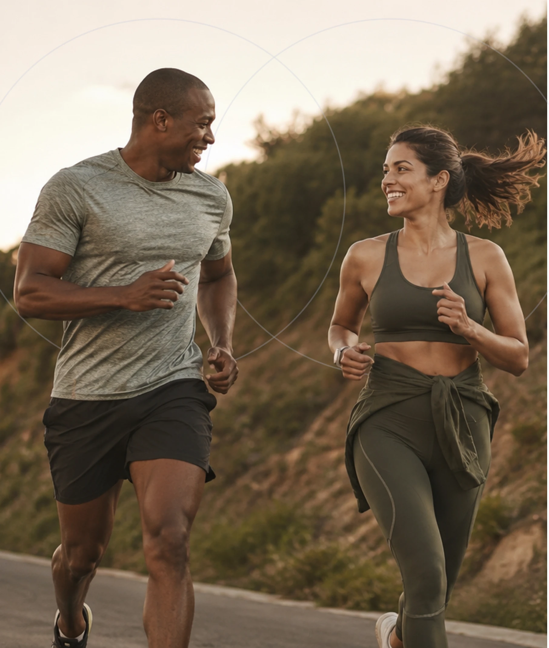 A man and woman smiling while running outdoors